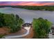 A captivating aerial view showcasing the house nestled among lush greenery by the calm lake at 8058 Edgewater Dr, Norwood, NC 28128
