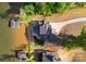 Breathtaking aerial shot of luxury home, private pool, and docks on the serene lake at 8058 Edgewater Dr, Norwood, NC 28128