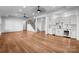 Finished basement with hardwood floors, a staircase, and a wet bar featuring stainless steel appliances and ample cabinet space at 8058 Edgewater Dr, Norwood, NC 28128
