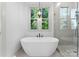 Bright bathroom featuring soaking tub with modern fixtures and glass enclosed shower at 8058 Edgewater Dr, Norwood, NC 28128