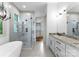 Modern bathroom features a glass shower with rainfall showerhead, soaking tub, and a double sink vanity at 8058 Edgewater Dr, Norwood, NC 28128