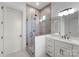 Modern bathroom featuring walk-in shower, neutral tile, and updated vanity at 8058 Edgewater Dr, Norwood, NC 28128