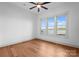 Cozy bedroom with hardwood floors, natural light from oversized windows, and a ceiling fan at 8058 Edgewater Dr, Norwood, NC 28128