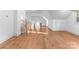 Spacious bonus room boasts hardwood floors, abundant natural light, and modern staircase at 8058 Edgewater Dr, Norwood, NC 28128