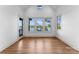 Bright bonus room features hardwood floors, natural light from oversized windows, and a view of the lake at 8058 Edgewater Dr, Norwood, NC 28128