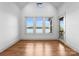 Bright bonus room features hardwood floors, natural light from oversized windows, and a view of the lake at 8058 Edgewater Dr, Norwood, NC 28128