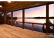 Enjoy lake views from this covered deck with wood flooring and railing at 8058 Edgewater Dr, Norwood, NC 28128