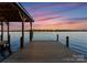 Beautiful sunset view from the private wooden dock on the lake at 8058 Edgewater Dr, Norwood, NC 28128