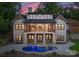 Striking two-story home with a spacious balcony, stone pillars, and a sparkling pool for ultimate relaxation and entertainment at 8058 Edgewater Dr, Norwood, NC 28128