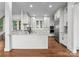 Modern kitchen features white cabinets, marble countertops, stainless steel appliances, and hardwood floors for a sleek design at 8058 Edgewater Dr, Norwood, NC 28128