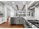 Open-concept kitchen with stainless steel appliances, a central island, and views of a lake at 8058 Edgewater Dr, Norwood, NC 28128
