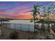 Lakefront property with colorful sunset and beautiful gazebo over the water at 8058 Edgewater Dr, Norwood, NC 28128