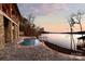 Elegant lakeside pool area with a charming dock, offering stunning views and a tranquil escape by the water at 8058 Edgewater Dr, Norwood, NC 28128