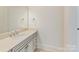 Bright bathroom with a single vanity, neutral countertop, and vanity mirror at 825 Hudson Pl, Davidson, NC 28036