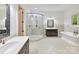 Spacious bathroom featuring double vanity, glass shower, stand alone tub, and natural light at 825 Hudson Pl, Davidson, NC 28036