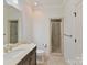 Bright bathroom showcases glass-enclosed shower, tile floor, vanity and white walls and trim at 825 Hudson Pl, Davidson, NC 28036