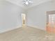 Neutral bedroom with carpeted floors, white trim, and a view of an adjoining bathroom at 825 Hudson Pl, Davidson, NC 28036