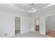 Spacious bedroom with a tray ceiling, neutral carpet, and two entrances to the bathroom and closet at 825 Hudson Pl, Davidson, NC 28036
