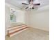 Bonus room featuring a split level, neutral carpet and view of an additional room at 825 Hudson Pl, Davidson, NC 28036