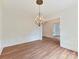Elegant dining room with hardwood floors, decorative molding, and an ornate chandelier at 825 Hudson Pl, Davidson, NC 28036