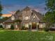 Elegant exterior of a grand home features a lush front lawn and beautiful landscaping, a warm welcome at 825 Hudson Pl, Davidson, NC 28036