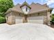 Spacious three-car garage offering ample parking and storage space, surrounded by lush greenery at 825 Hudson Pl, Davidson, NC 28036