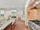 Open kitchen with granite countertops, stainless appliances, and an island sink provides ample workspace at 825 Hudson Pl, Davidson, NC 28036