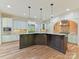 Spacious kitchen features custom cabinets, a large island, and stainless steel appliances at 825 Hudson Pl, Davidson, NC 28036
