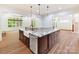 This open kitchen design features a large island, granite countertops, and a sink at 825 Hudson Pl, Davidson, NC 28036