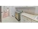 Bright laundry room features custom cabinetry, countertops, and tiled floors at 825 Hudson Pl, Davidson, NC 28036