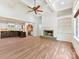 Open living room with a fireplace, built-in shelves, and a kitchen view at 825 Hudson Pl, Davidson, NC 28036
