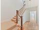 Staircase featuring carpeted steps and painted wooden handrails, leading to the upper level at 825 Hudson Pl, Davidson, NC 28036