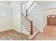 Elegant staircase featuring hardwood floors, stained wood banister, and natural light at 825 Hudson Pl, Davidson, NC 28036