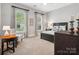 Comfortable bedroom with carpeted floors, soft lighting, and large windows that offer a serene view at 894 Stratford Run Dr, Fort Mill, SC 29708