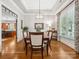 Formal dining room featuring a tray ceiling, hardwood floors, and ample natural light from a large window at 894 Stratford Run Dr, Fort Mill, SC 29708
