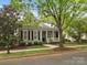 Beautifully landscaped home with a cozy front porch and classic architectural details at 894 Stratford Run Dr, Fort Mill, SC 29708