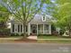 Charming single-story home with a covered porch, complemented by mature trees and manicured landscaping at 894 Stratford Run Dr, Fort Mill, SC 29708