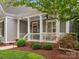 Charming front porch with white columns, detailed trim, and well-manicured landscaping at 894 Stratford Run Dr, Fort Mill, SC 29708
