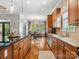 Gourmet kitchen includes wood cabinetry, granite countertops, and stainless appliances, with a view to breakfast room at 894 Stratford Run Dr, Fort Mill, SC 29708