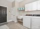 Functional laundry room equipped with a sink, washer, dryer, and plenty of cabinet storage at 894 Stratford Run Dr, Fort Mill, SC 29708