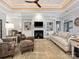 Bright living room boasts custom built-ins, a cozy fireplace, and tray ceiling with great natural light at 894 Stratford Run Dr, Fort Mill, SC 29708