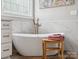 Bathroom with a soaking tub, marble walls, stylish fixtures and wood flooring at 894 Stratford Run Dr, Fort Mill, SC 29708
