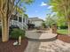 Backyard patio with stone retaining wall, seating, and a glimpse of the screened-in back porch at 894 Stratford Run Dr, Fort Mill, SC 29708