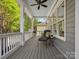 Cozy porch with outdoor seating, ceiling fan, and grey wood flooring, great for enjoying the weather at 894 Stratford Run Dr, Fort Mill, SC 29708