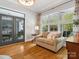 Bright sitting room features a comfortable couch, wood floors, and access to outdoor living space at 894 Stratford Run Dr, Fort Mill, SC 29708