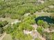 Aerial shot showcasing the property's proximity to a golf course and a serene lake at 9012 Saint Thomas Ln, Charlotte, NC 28277