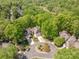Overhead view of the homes showing their proximity to the golf course and lush tree coverage surrounding the neighborhood at 9012 Saint Thomas Ln, Charlotte, NC 28277