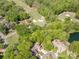 Aerial shot of golf course-adjacent home with mature trees, manicured lawns, and community landscaping at 9012 Saint Thomas Ln, Charlotte, NC 28277