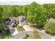 Gorgeous aerial view of homes with manicured lawns, attached garages and lush, mature trees surrounding the property at 9012 Saint Thomas Ln, Charlotte, NC 28277