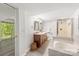 Well-lit bathroom with a double vanity, soaking tub, and glass-enclosed shower at 9012 Saint Thomas Ln, Charlotte, NC 28277